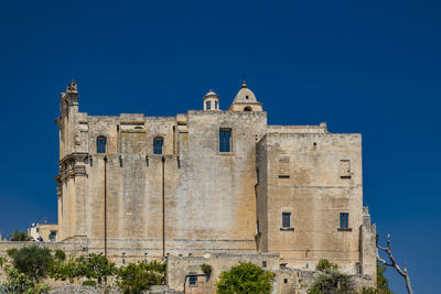 Low angle view of building against blue sky