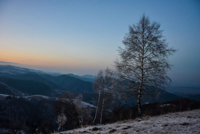 Scenic view of snow covered landscape against sky during sunset