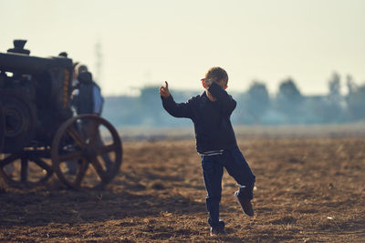 Full length of woman on field against sky