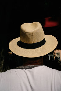 Rear view portrait of man wearing hat at night