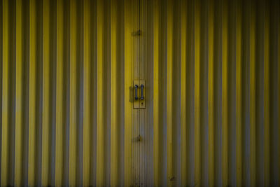 Full frame shot of closed yellow store gate