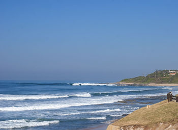 Scenic view of sea against clear blue sky