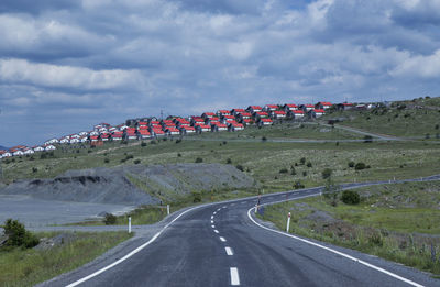 Road by land against sky