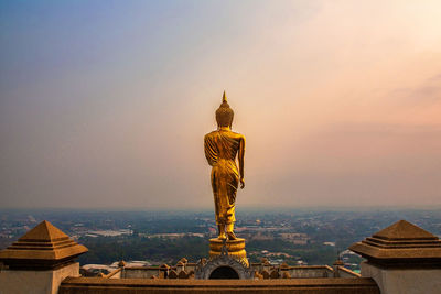 Statue of temple against building