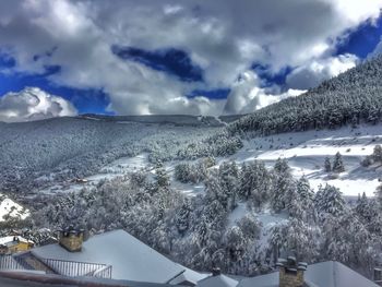 Snow covered landscape against sky