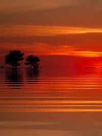 Scenic view of lake against romantic sky at sunset