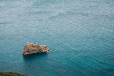 High angle view of rocks in sea