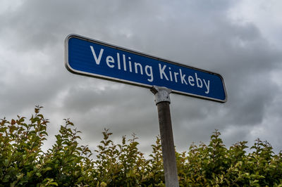 Low angle view of road sign against sky