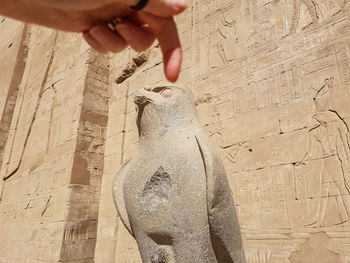 Close-up of man working on sand