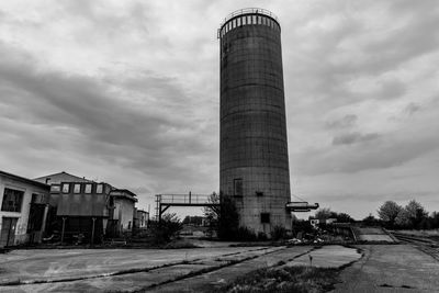 Low angle view of factory against sky in city