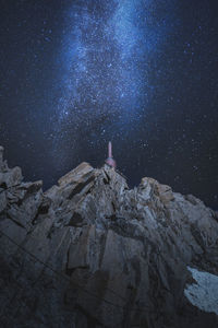 Rock formation on building against sky at night