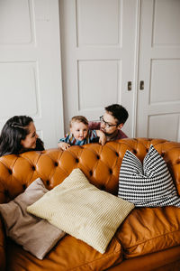 Young couple sitting on sofa at home