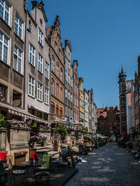 Street amidst buildings in town against sky