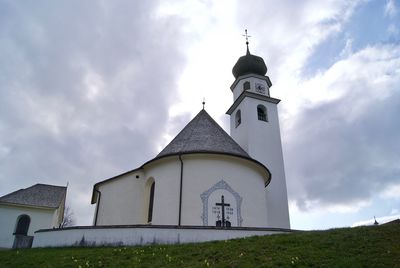 Low angle view of bell tower against sky