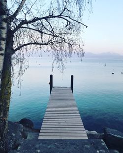 Pier over lake against sky