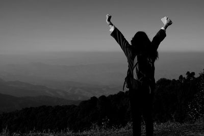 Low angle view of woman standing on field against sky