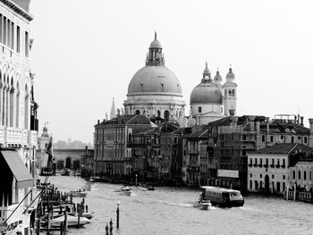 Santa maria della salute by grand canal against sky on sunny day in city