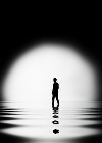 Silhouette man standing in water