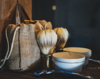 Close-up of shaving accessories on table