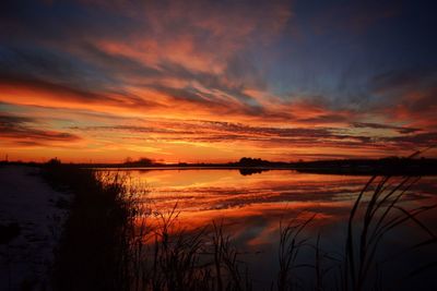 Scenic view of lake against sky during sunset