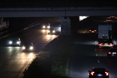 Cars on road in city at night