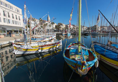 Boats moored at harbor in city