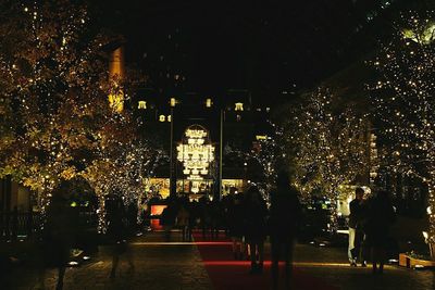 Illuminated street lights in city at night