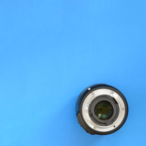 Directly above shot of lens on blue background