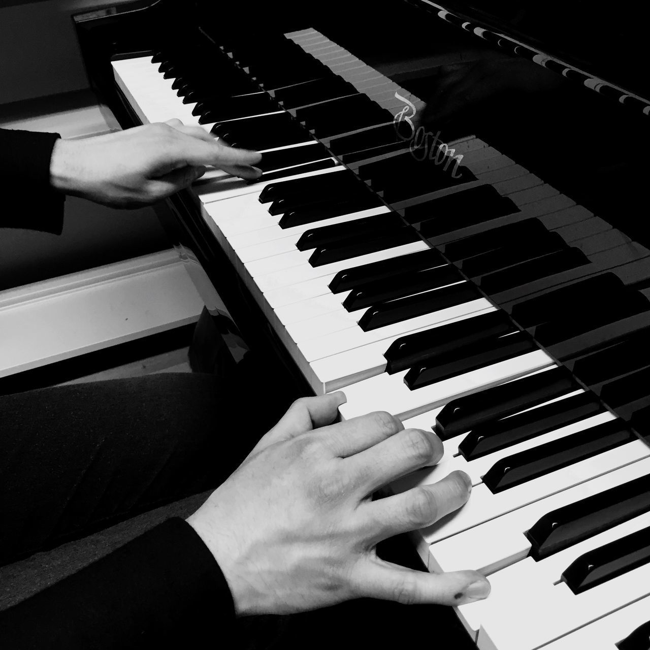 LOW ANGLE VIEW OF MAN PLAYING PIANO AT MUSIC CONCERT