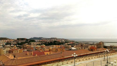 High angle view of cityscape against cloudy sky