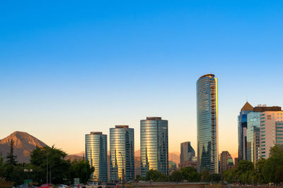 View of modern buildings against clear blue sky