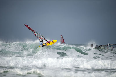 Man in boat on sea against sky