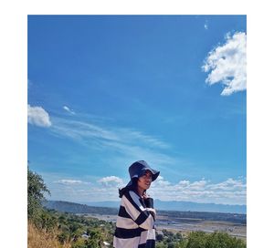 Man standing against blue sky