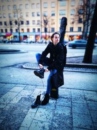 Full length portrait of man standing on footpath