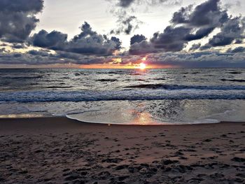 Scenic view of beach against sky during sunset