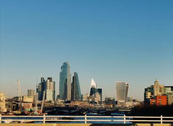 Modern buildings in city against clear sky