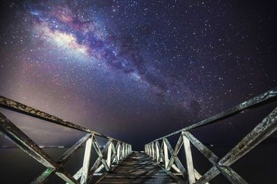 Footbridge against milky way at night