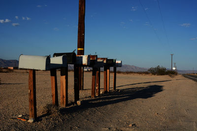 Fence at beach against sky