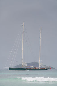 Sailboat sailing on sea against clear sky