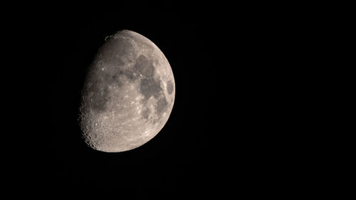 Low angle view of moon against clear sky at night