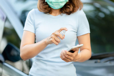 Midsection of woman using mobile phone