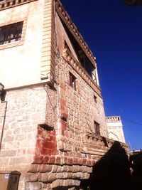 Low angle view of building against blue sky