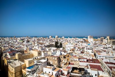 High angle view of townscape against clear blue sky