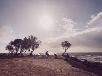 People on beach against sky