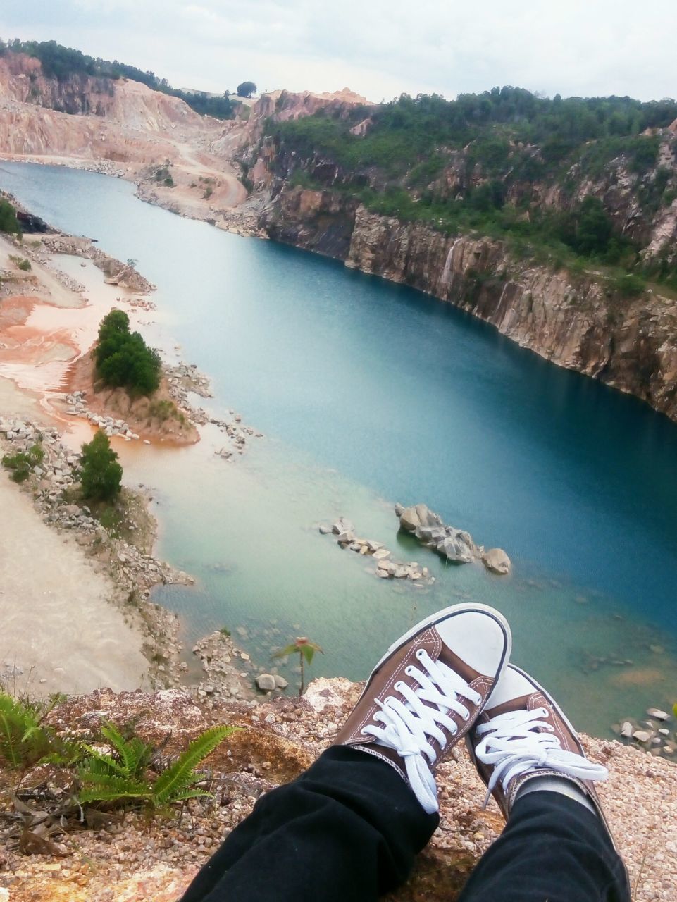 low section, water, person, personal perspective, shoe, leisure activity, lifestyles, nature, scenics, lake, tranquility, men, tranquil scene, human foot, mountain, beauty in nature, high angle view