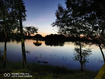 Scenic view of lake against sky at sunset