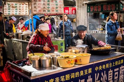 Group of people at market stall