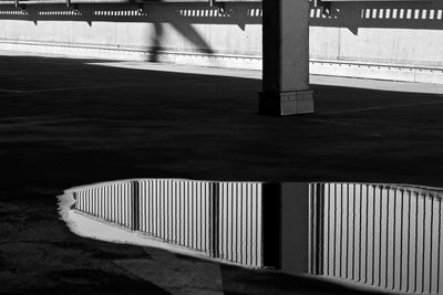 High angle view of bridge reflection in puddle