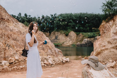 Full length of man photographing with mobile phone in water