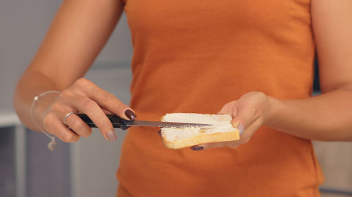 Midsection of woman holding ice cream